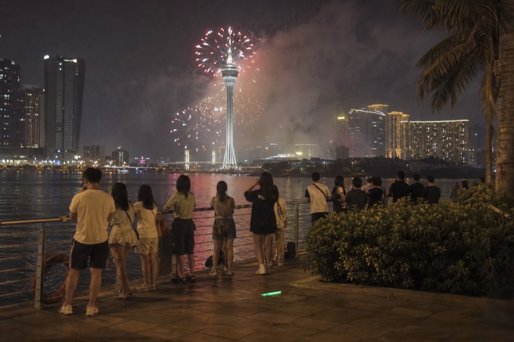 Fireworks bursting over the seafront night sky above Macau Tower