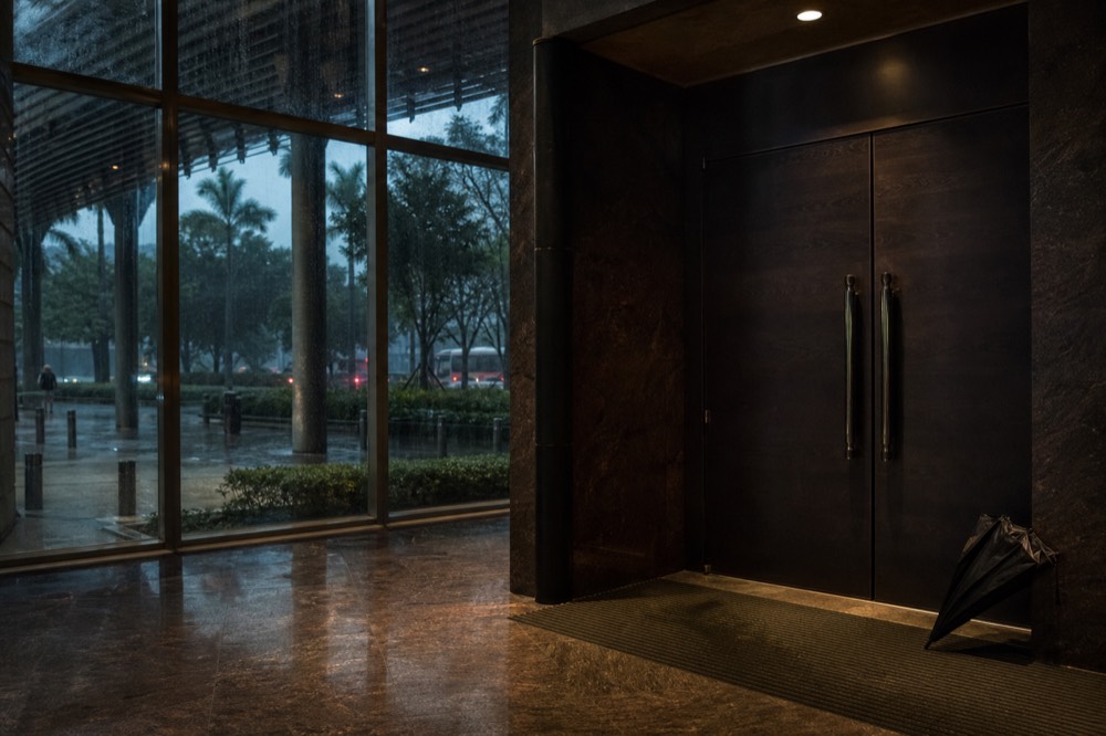 A theatre foyer with a closed stage door and warm evening lighting