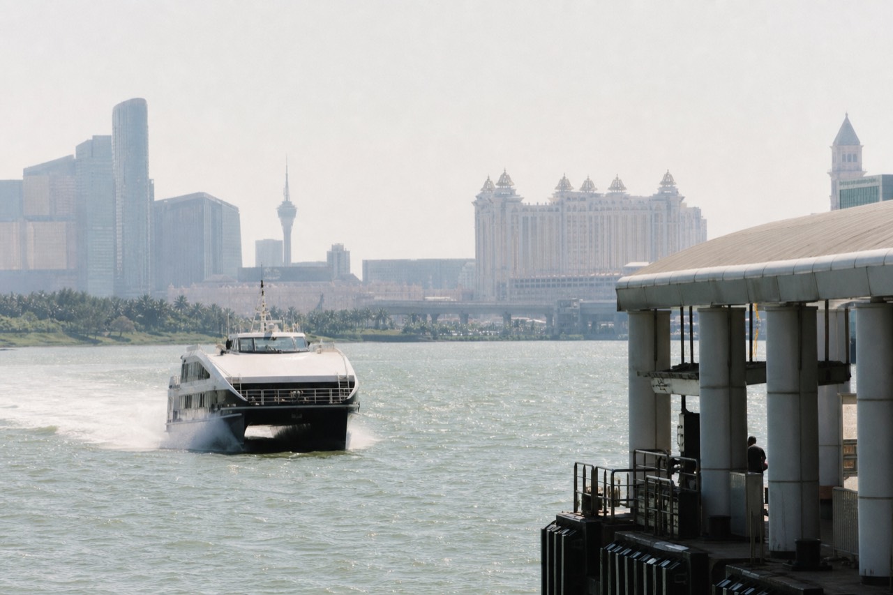 A high-speed ferry cutting across open water between Hong Kong and Macau