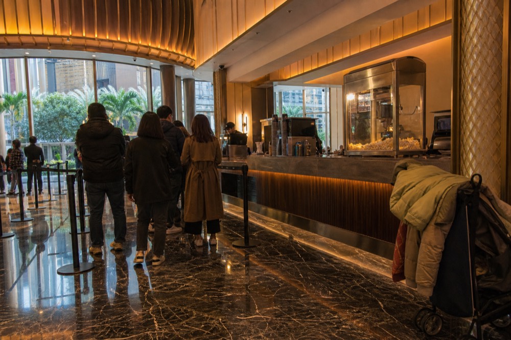 Concession stand and theatre foyer with warm lighting before a performance