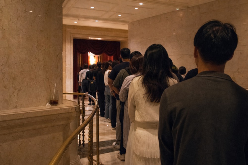 Lit theatre foyer entrance inside a Cotai resort before an evening performance