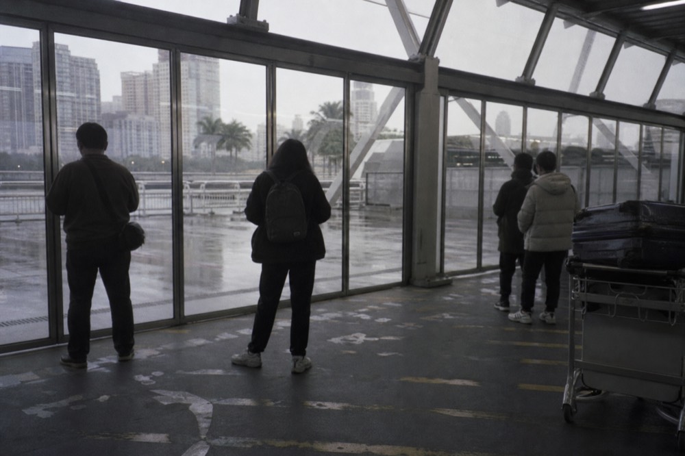 Ferry terminal departures hall with travellers waiting at evening gates