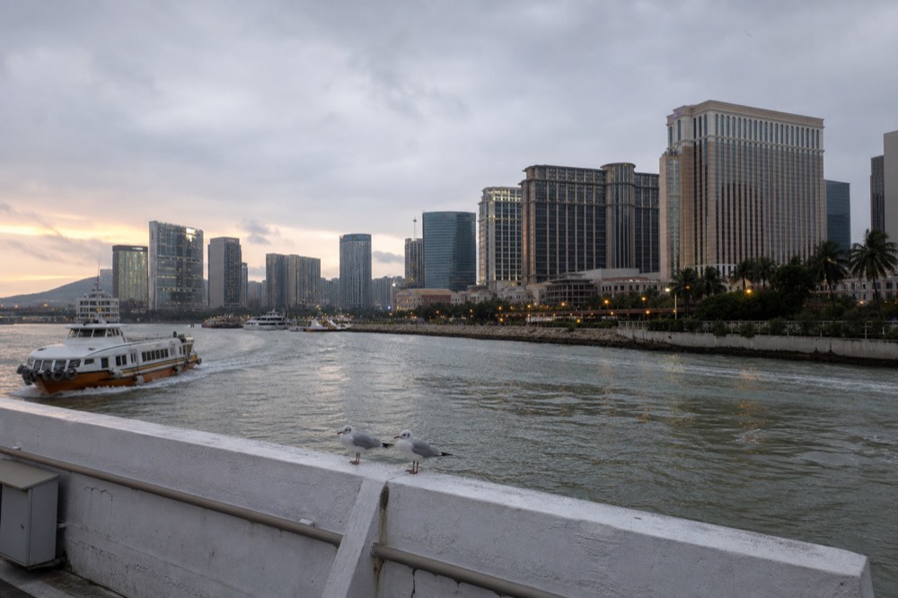 Cotai resort district skyline seen across water in evening light