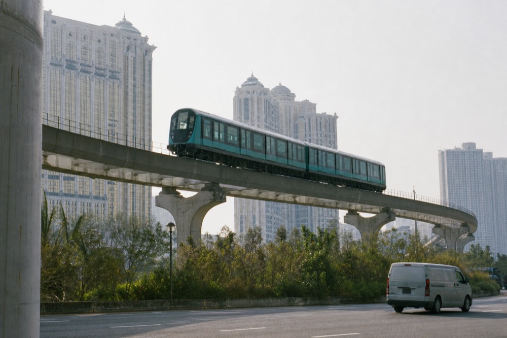 A light rail transit viaduct crossing Cotai with resort towers behind
