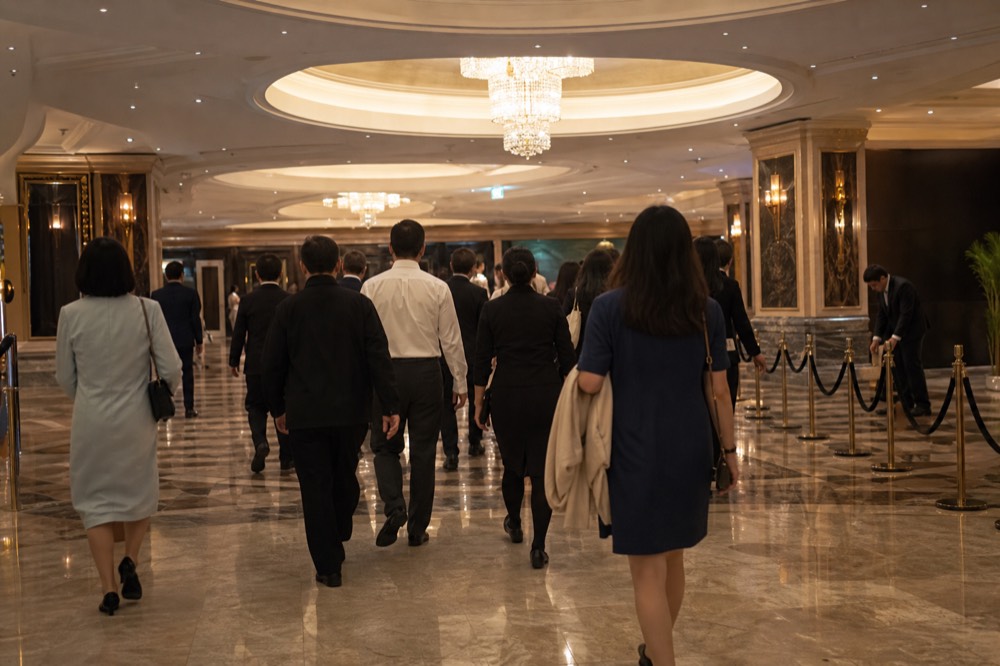 Theatre foyer filling with arriving audience members before an evening performance