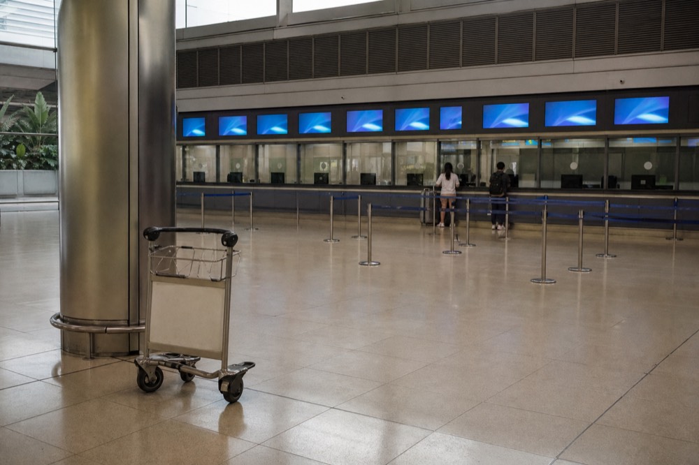 Ticket counters and fare boards at a modern cross-border transport terminal