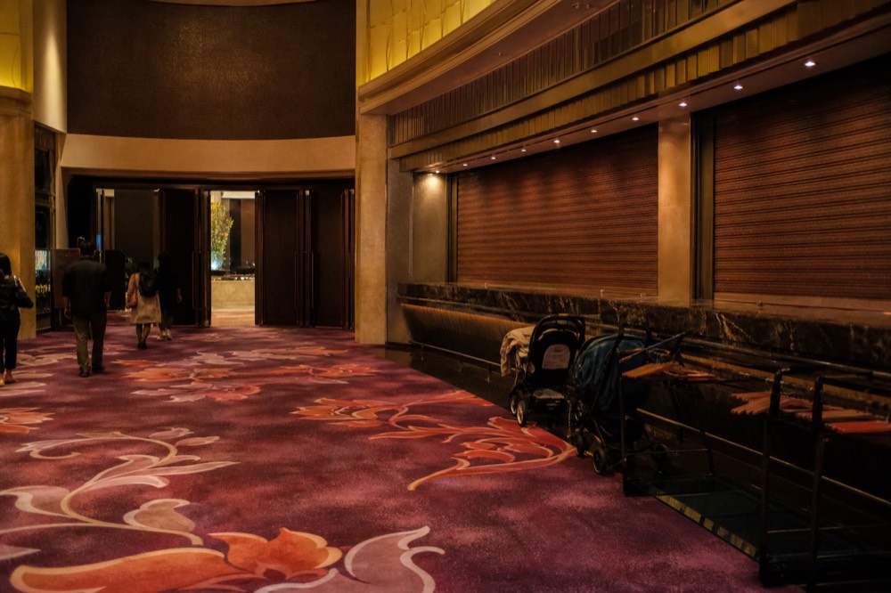 A theatre foyer with a concession stand and entry doors before a performance