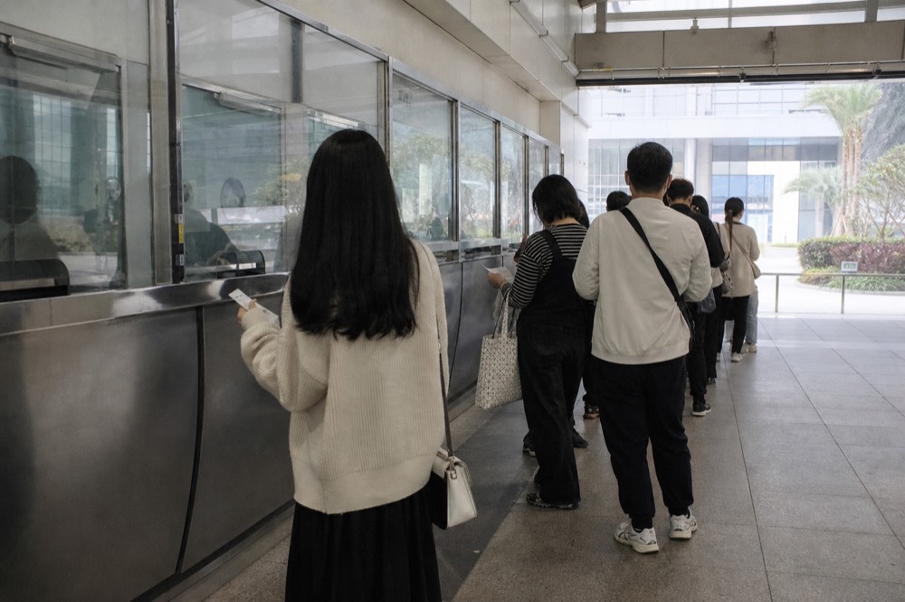 A ferry ticket counter and queue at a Hong Kong terminal