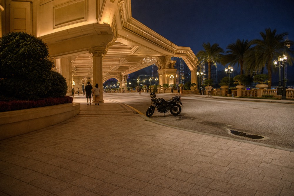 An evening resort theatre entrance with warm lighting and a quiet plaza