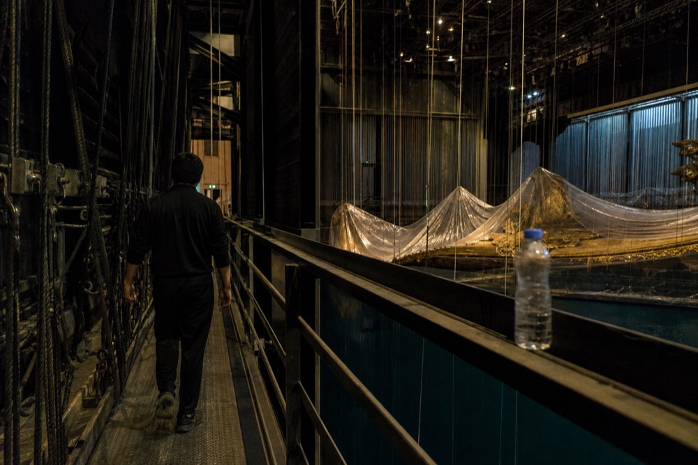 Backstage walkway above the stage with rigging and performance props