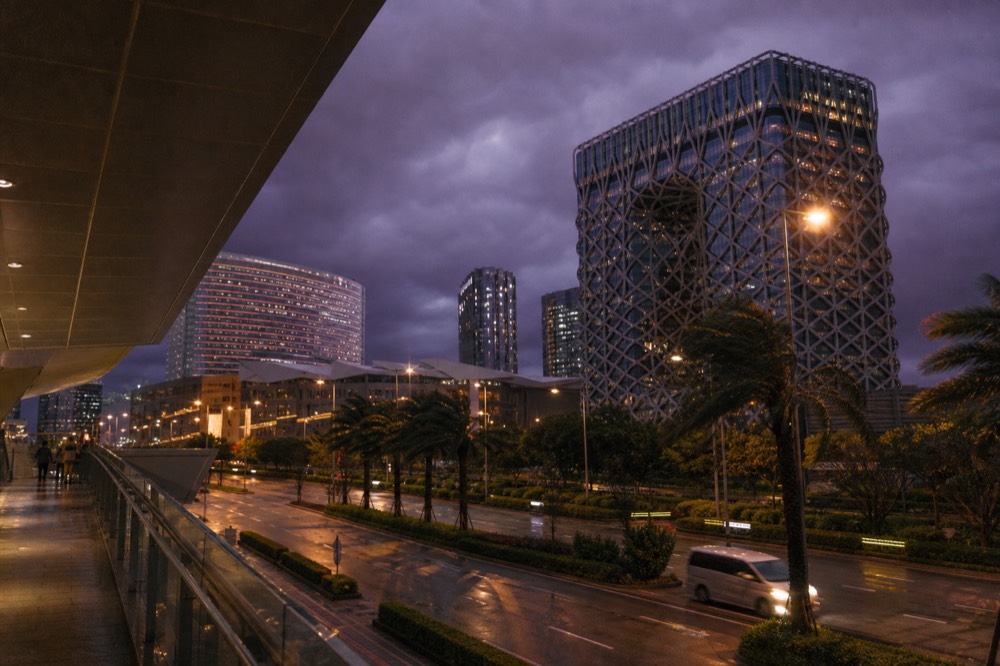 A storm-dark sky over Cotai resort towers before an evening performance