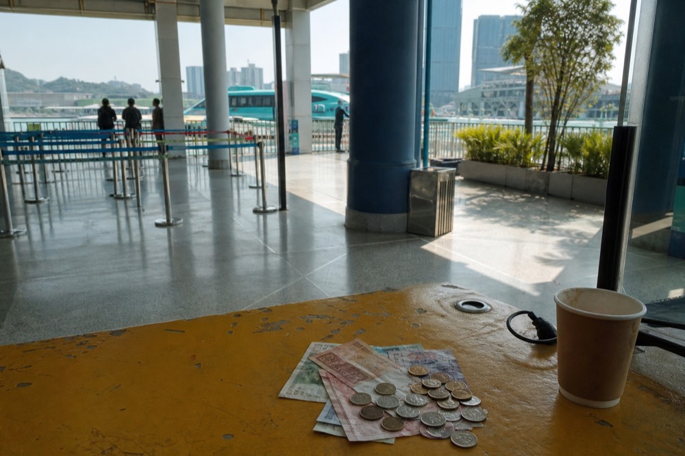 Macanese pataca notes and coins on a table