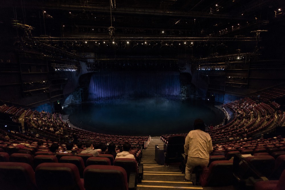 A grand theatre auditorium with a pool stage before a performance in Macau