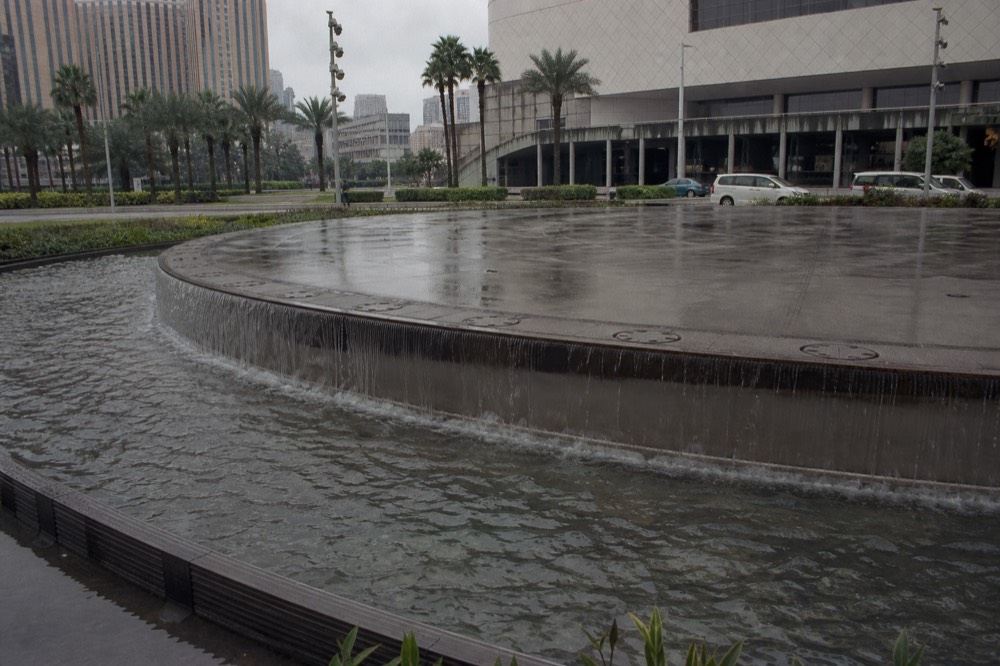 The circular centre stage of the water theatre mid-transformation between water and solid floor