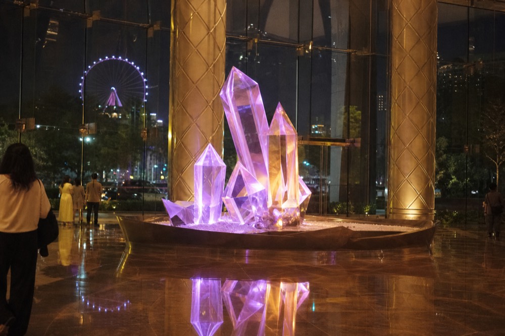 A glowing crystal display inside a resort lobby at night