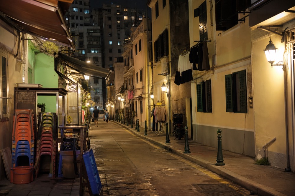 Narrow village lanes lit by warm street lamps at night