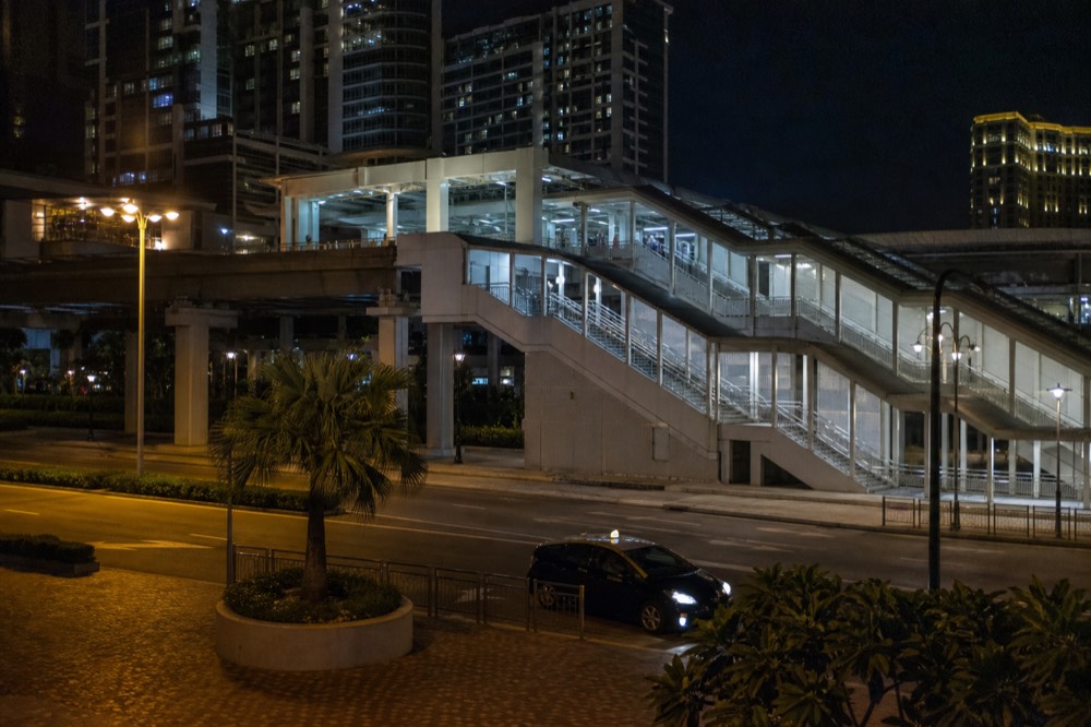 A lit resort promenade with walkways glowing at night
