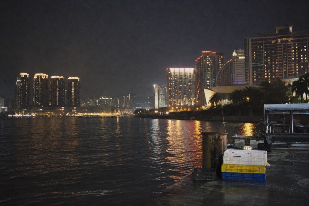 City lights of Macau seen across the water at night
