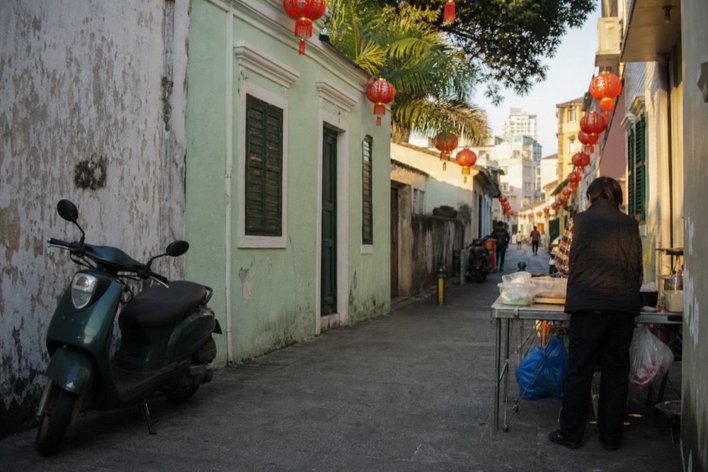 Taipa Village street with pastel colonial buildings and hanging lanterns
