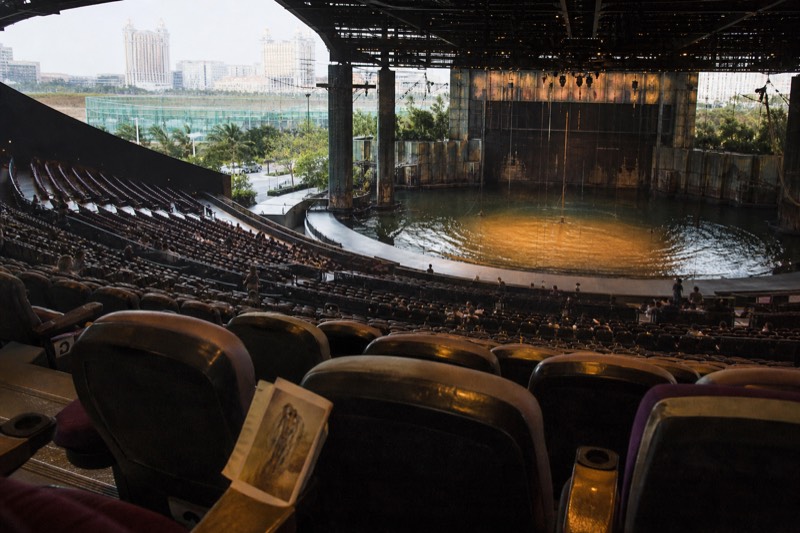The flooded stage of the House of Dancing Water seen from the seats, wide view